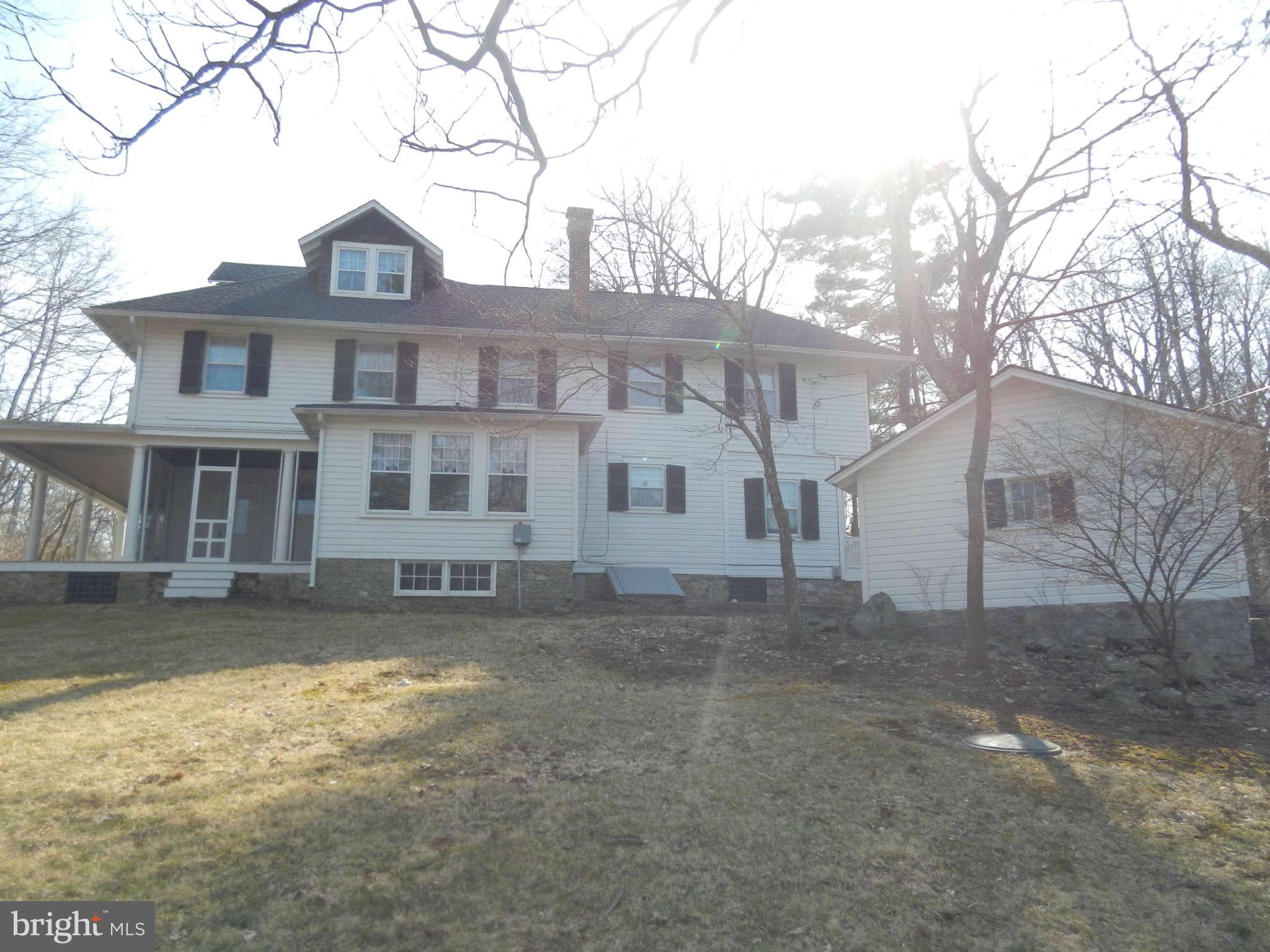5815 Rowland Hill Road Cascade, MD 21719 - Photo 28 of 30 a view of a large white house with a yard with a large tree