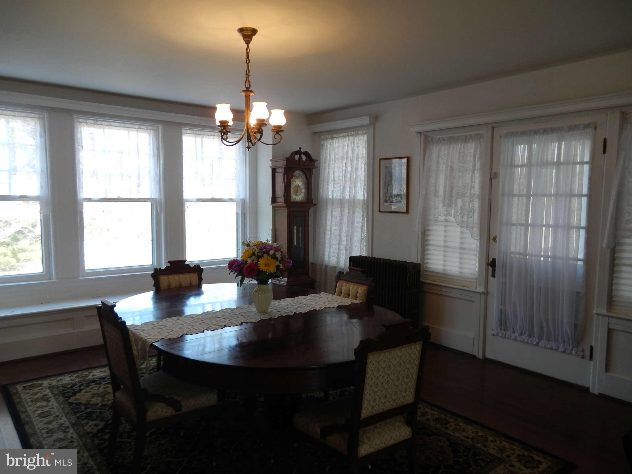 5815 Rowland Hill Road Cascade, MD 21719 - Photo 7 of 30 a dining room with a table chairs and a chandelier