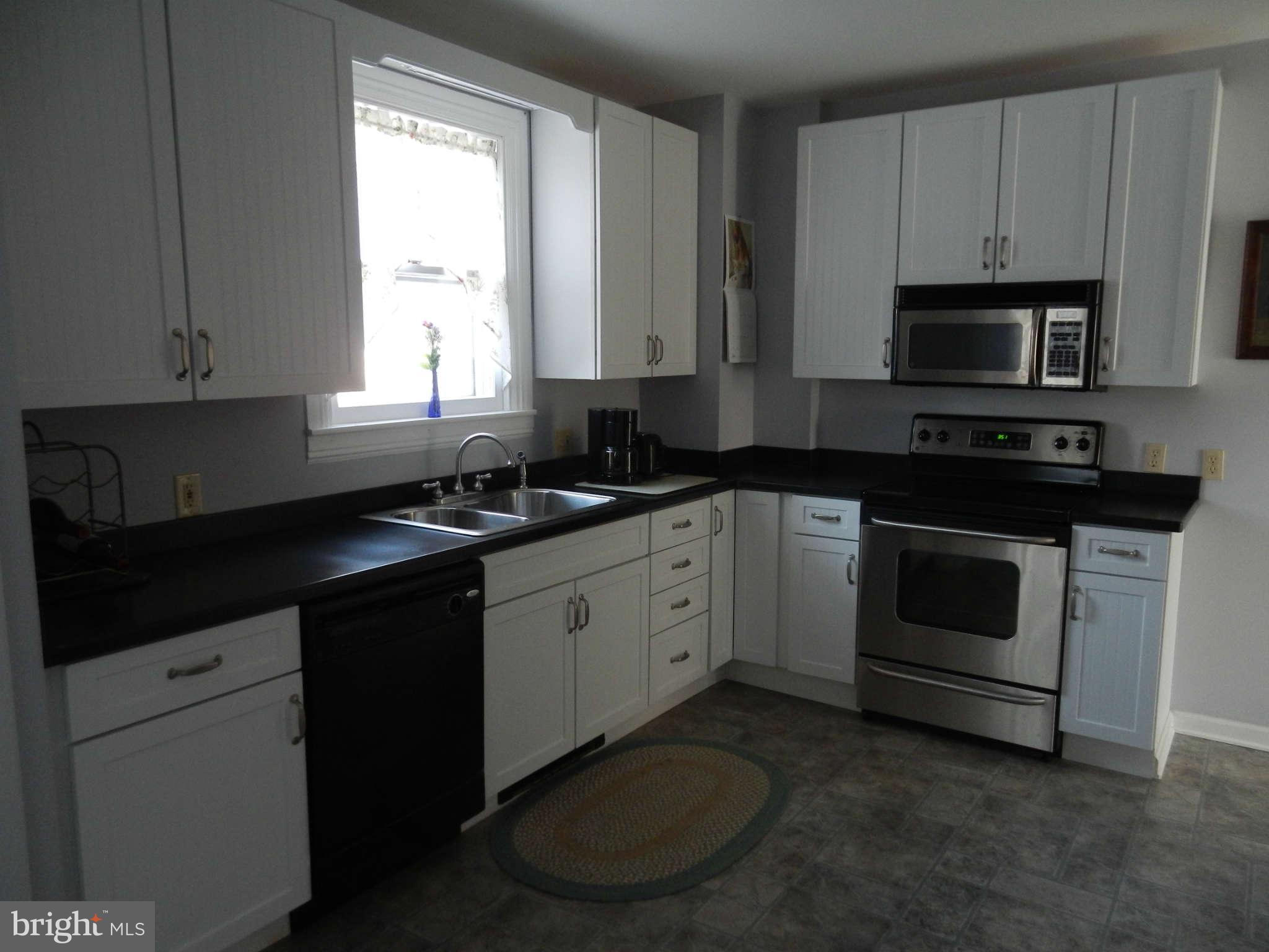 5815 Rowland Hill Road Cascade, MD 21719 - Photo 9 of 30 a kitchen with a sink stove and cabinets