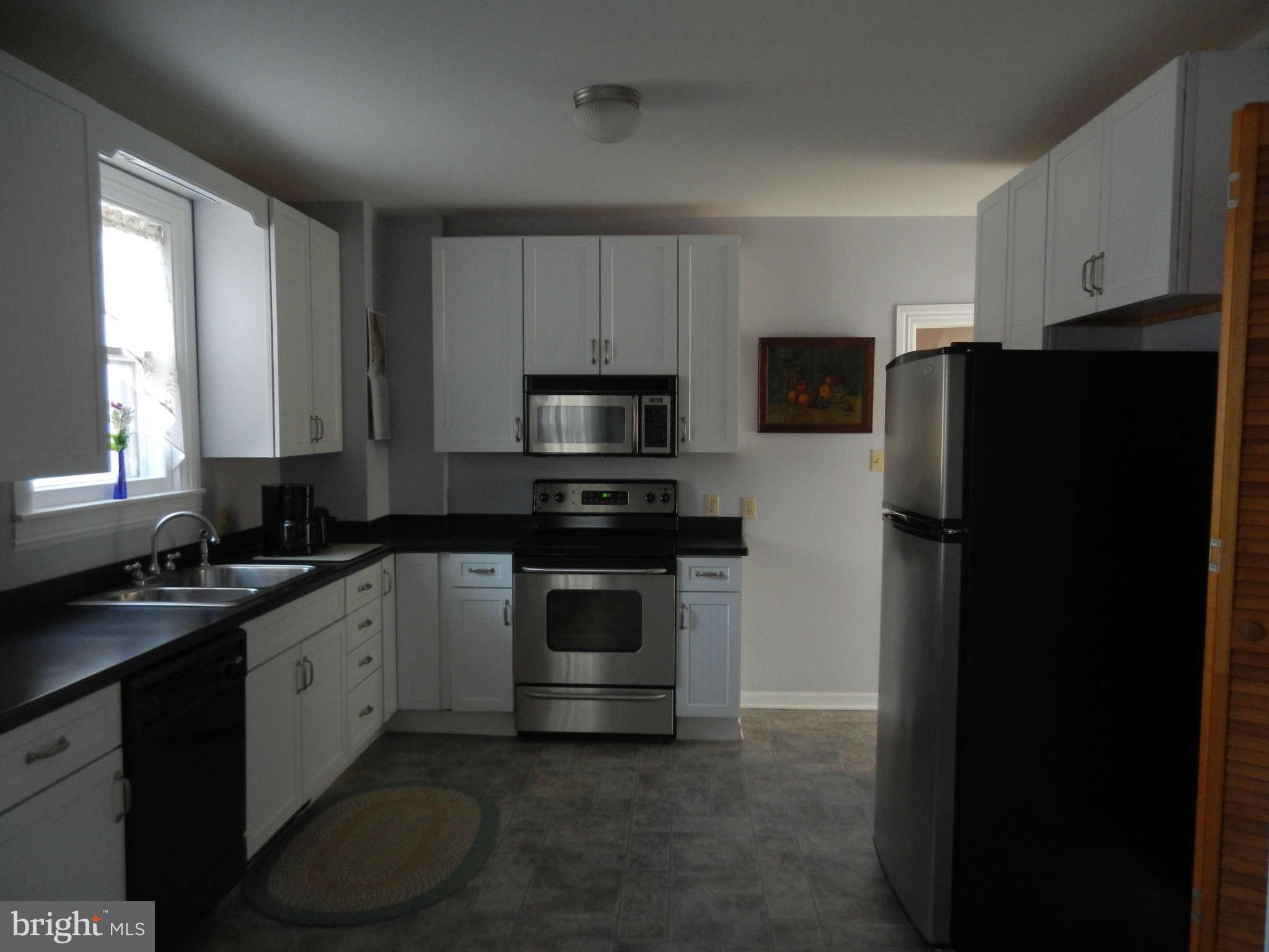 5815 Rowland Hill Road Cascade, MD 21719 - Photo 10 of 30 a kitchen with a refrigerator stove and microwave