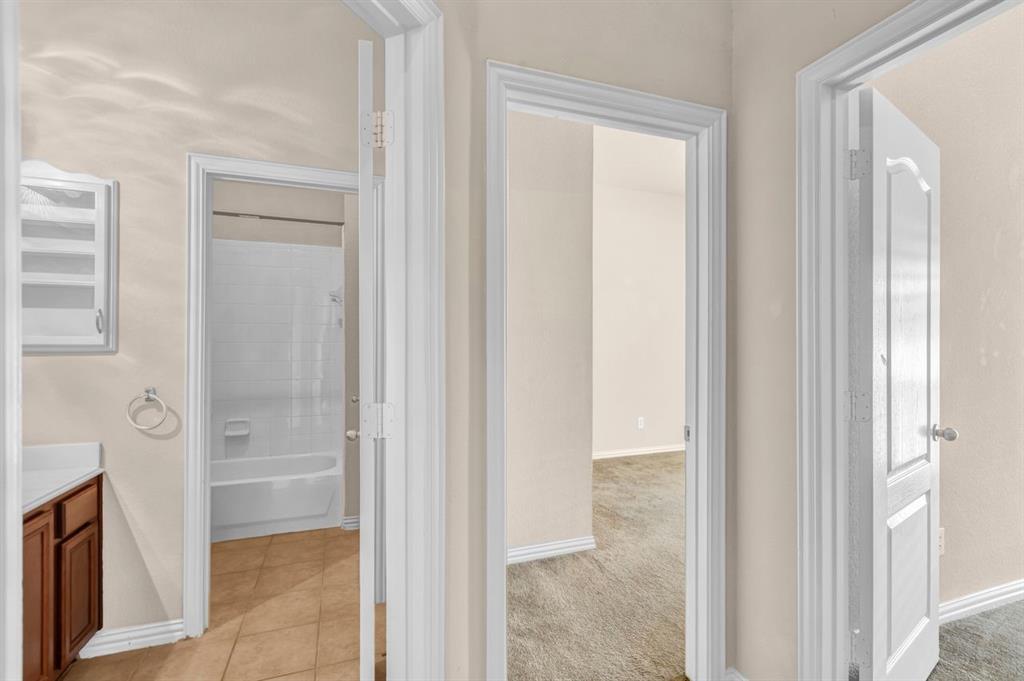 5316 Ridgeson Drive McKinney, TX 75071 - Photo 28 of 33 Hallway featuring neutral-toned walls, white trim, and doors with paneled detailing