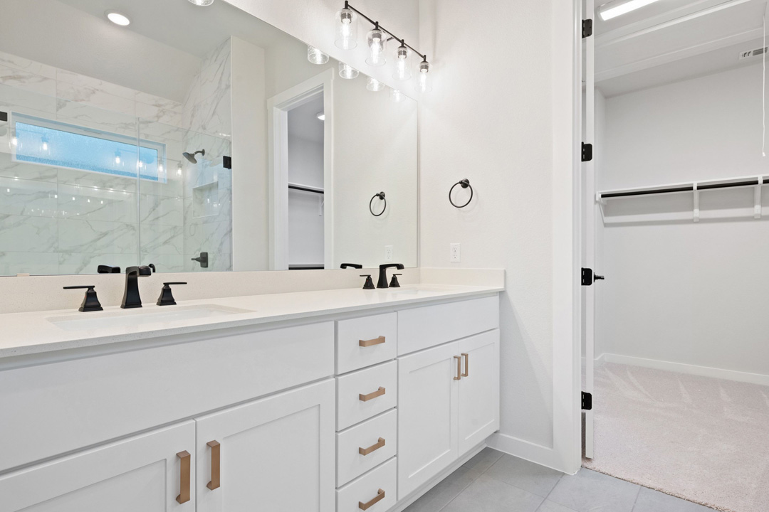 16201 Smithers Road Manor, TX 78653 - Photo 26 of 40 a bathroom with double vanity sink a shower and a mirror