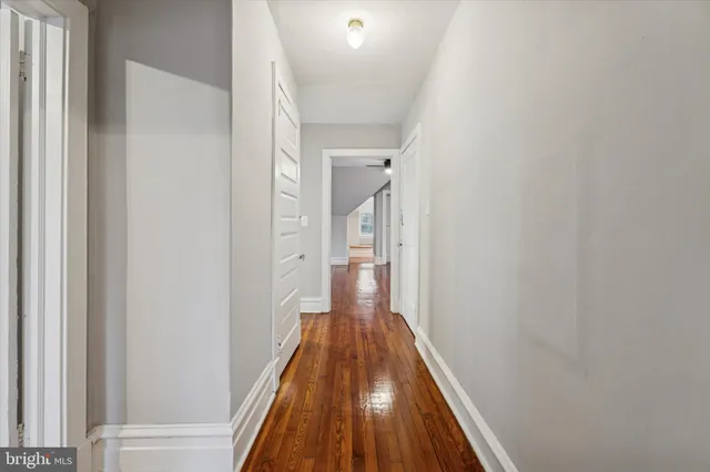 a view of a hallway with wooden floor