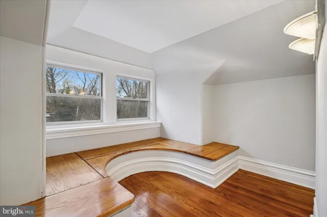 a view of a livingroom with wooden floor and a window
