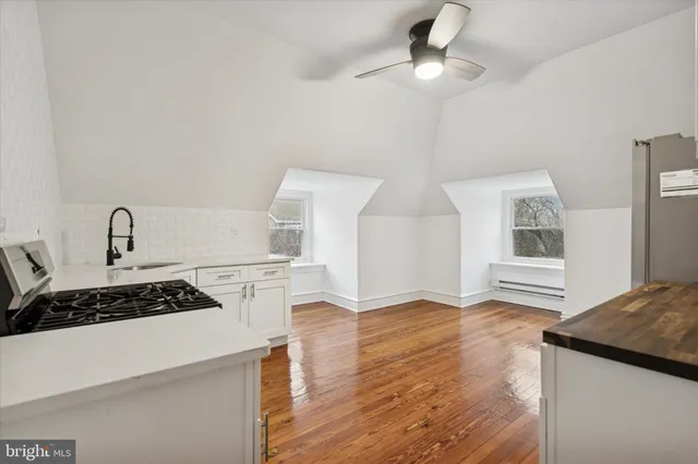 a kitchen with granite countertop a stove and a refrigerator