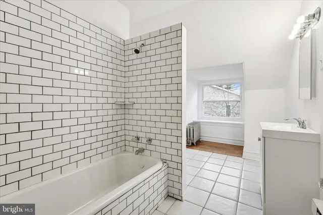 a bathroom with a bathtub and a sink
