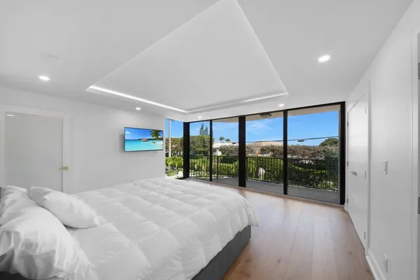 a bedroom with a large bed and a window