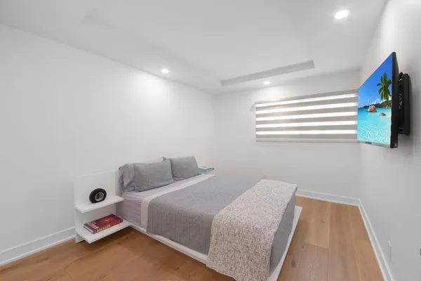 a bedroom with a bed and a window