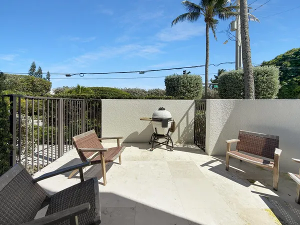 a roof deck with table and chairs