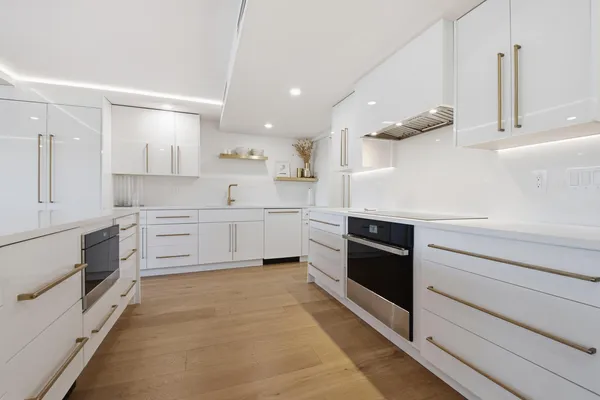 a view of a kitchen with counter top space and stainless steel appliances