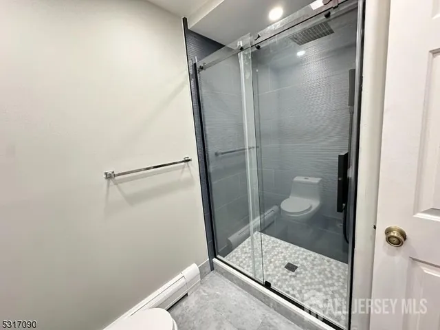 a bathroom with a sink a toilet and mirror