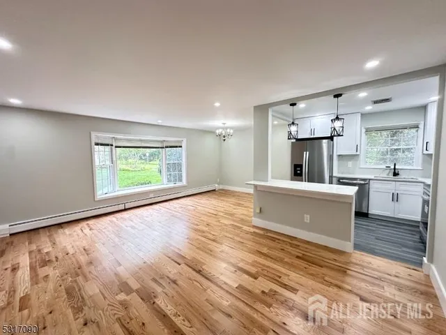 a view of kitchen with wooden floor and electronic appliances