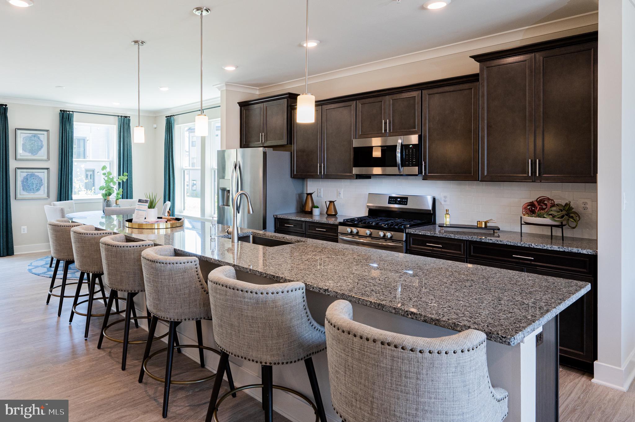 7209 Paper Way Glen Burnie, MD 21060 - Photo 12 of 40 a kitchen with granite countertop lots of counter top space and stainless steel appliances