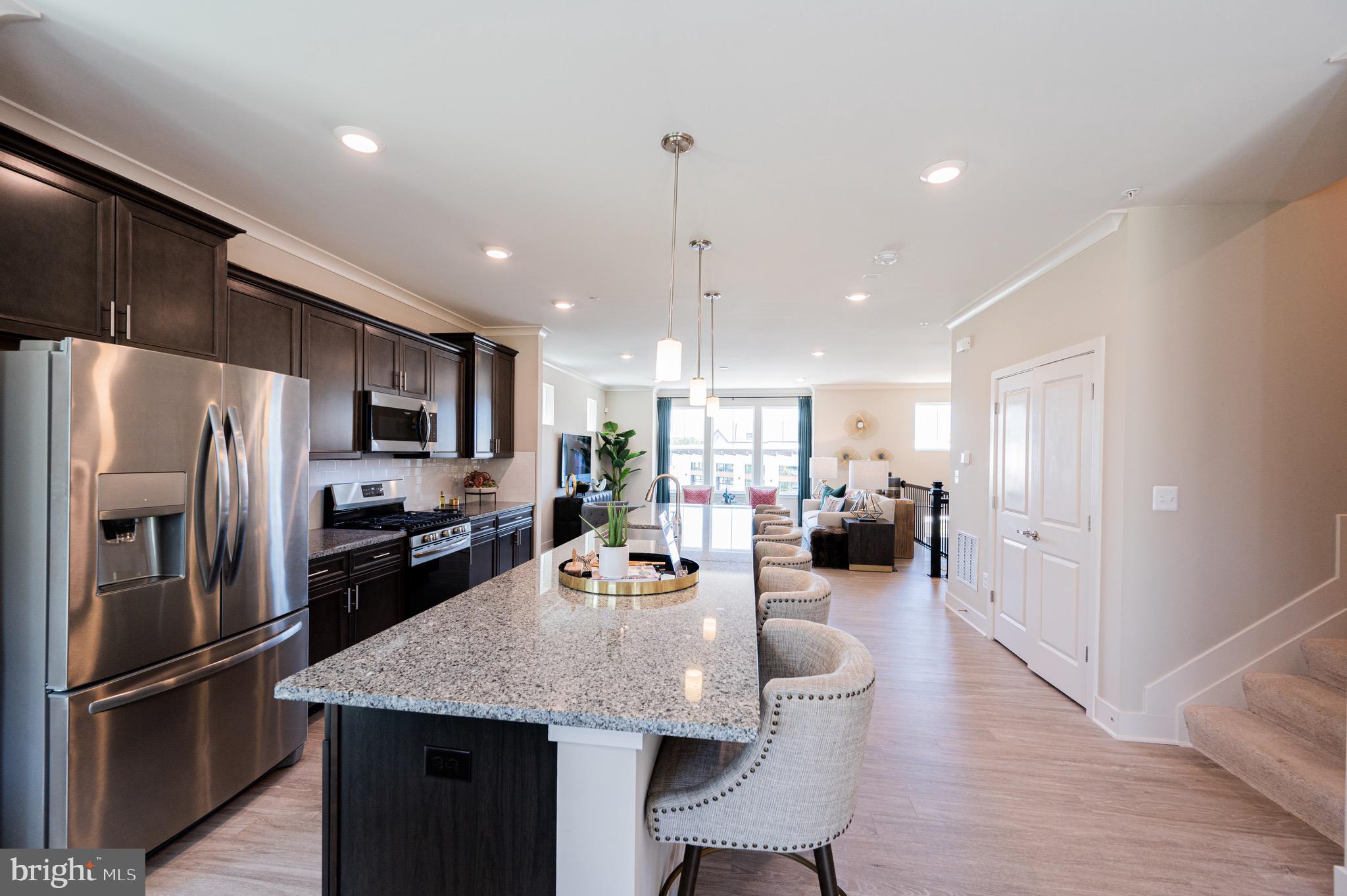7209 Paper Way Glen Burnie, MD 21060 - Photo 18 of 40 a large kitchen with sink a refrigerator and chairs