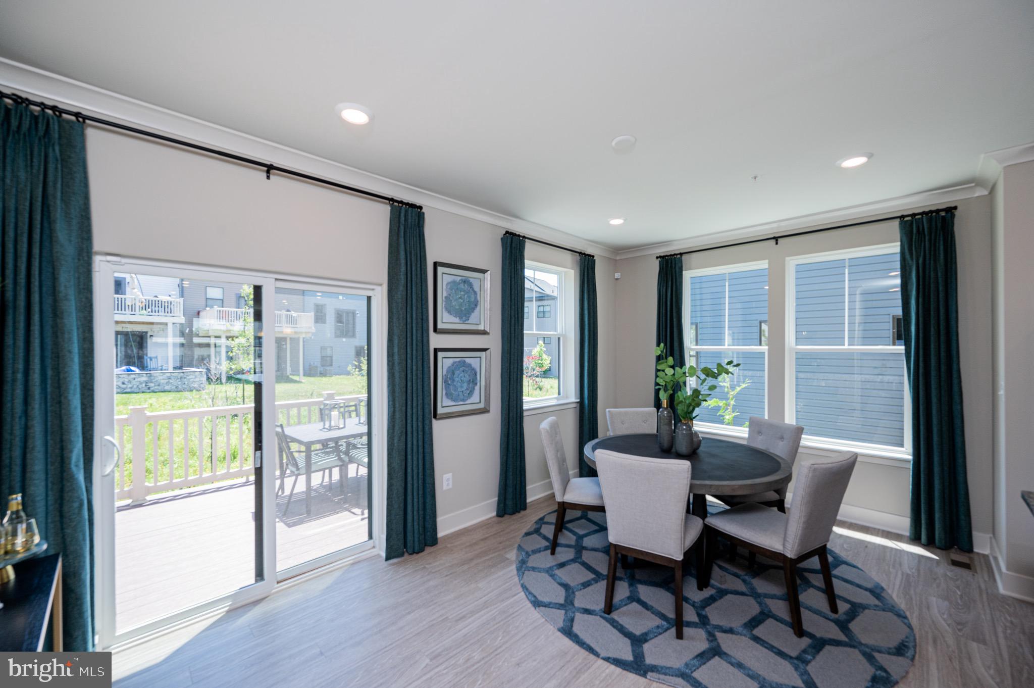 7209 Paper Way Glen Burnie, MD 21060 - Photo 22 of 40 a dining room with furniture and wooden floor