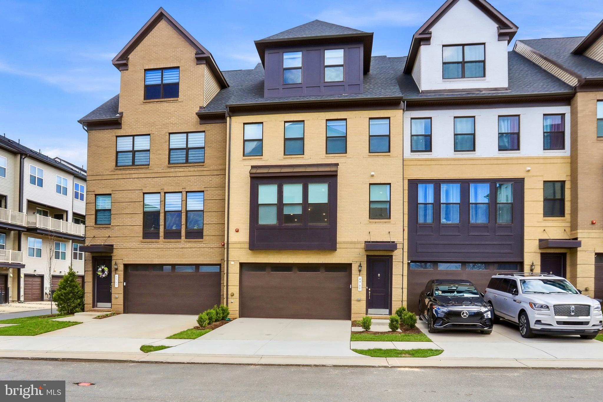 4965 Longmire Way Chantilly, VA 20151 - Photo 1 of 41 a front view of a residential apartment building with a yard