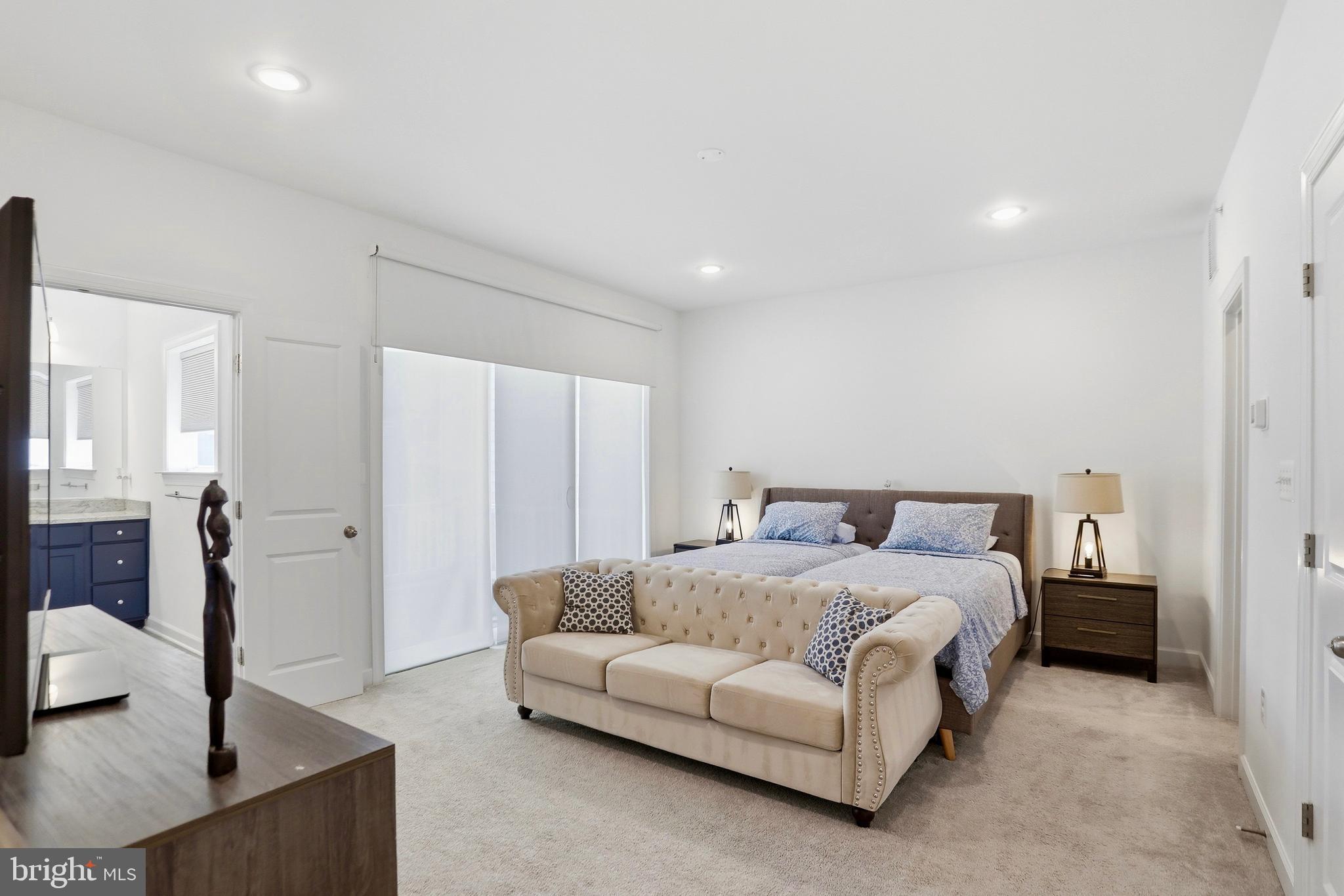 4965 Longmire Way Chantilly, VA 20151 - Photo 12 of 41 a spacious bedroom with a bed and a couch