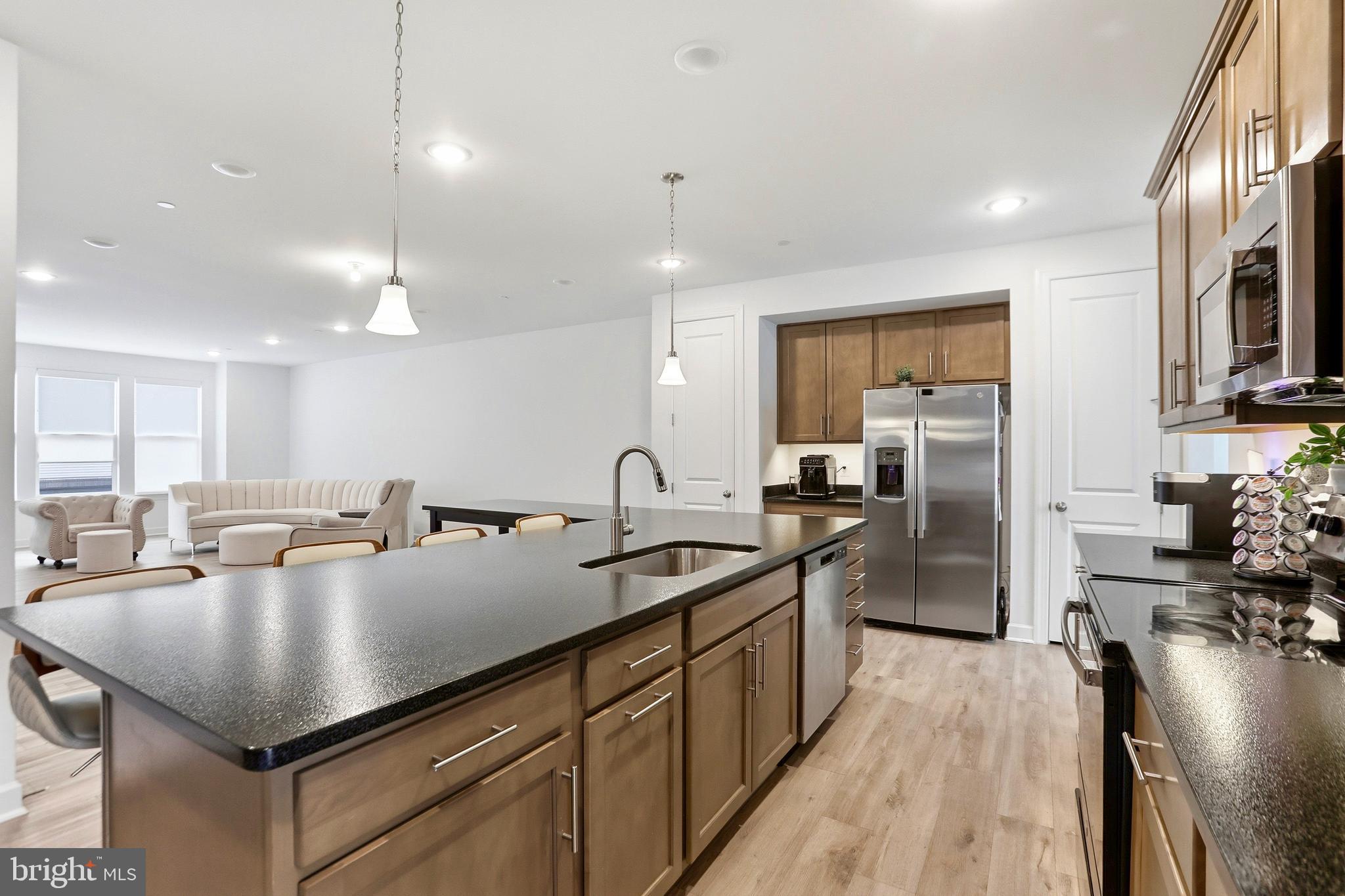 4965 Longmire Way Chantilly, VA 20151 - Photo 8 of 41 a kitchen with a sink a counter top space stainless steel appliances and cabinets