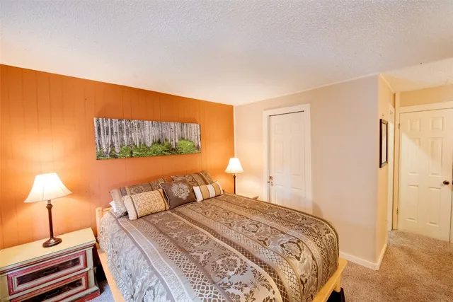 a bedroom with a bed and a lamp