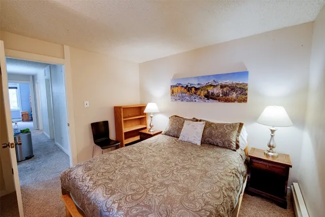 a bedroom with a bed and a lamp on table