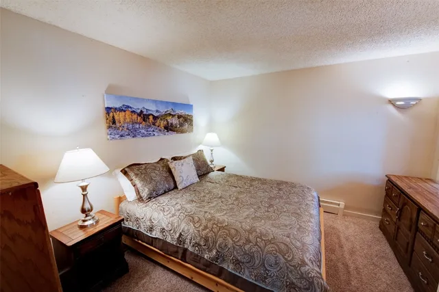 a bedroom with a bed and a night stand