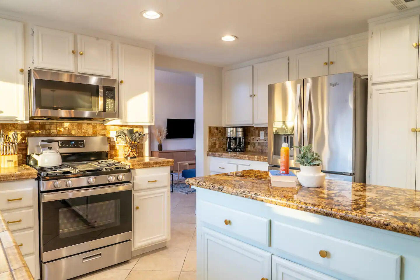 81032 Red Bluff Road Indio, CA 92201 - Photo 14 of 33 a kitchen with granite countertop a stove top oven microwave and refrigerator