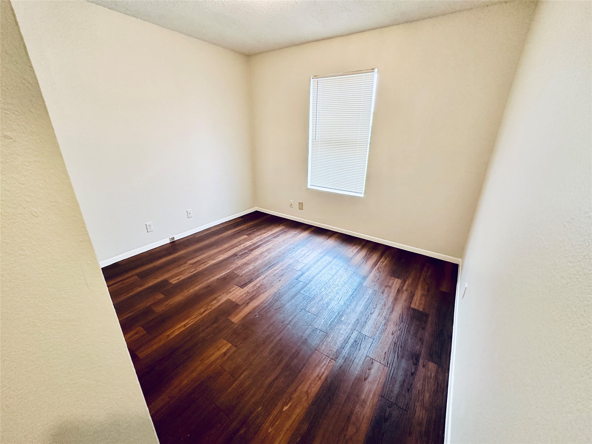 12505 Turtle Rock Road, Unit A Austin, TX 78729 - Photo 24 of 38 Rich hardwood floors create a warm and inviting atmosphere in this versatile space.