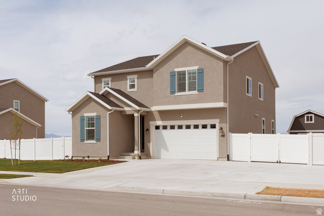 540 Lefty Lane Tooele, UT 84074 - Photo 3 of 48 Traditional-style house with an attached garage, stucco siding, and driveway