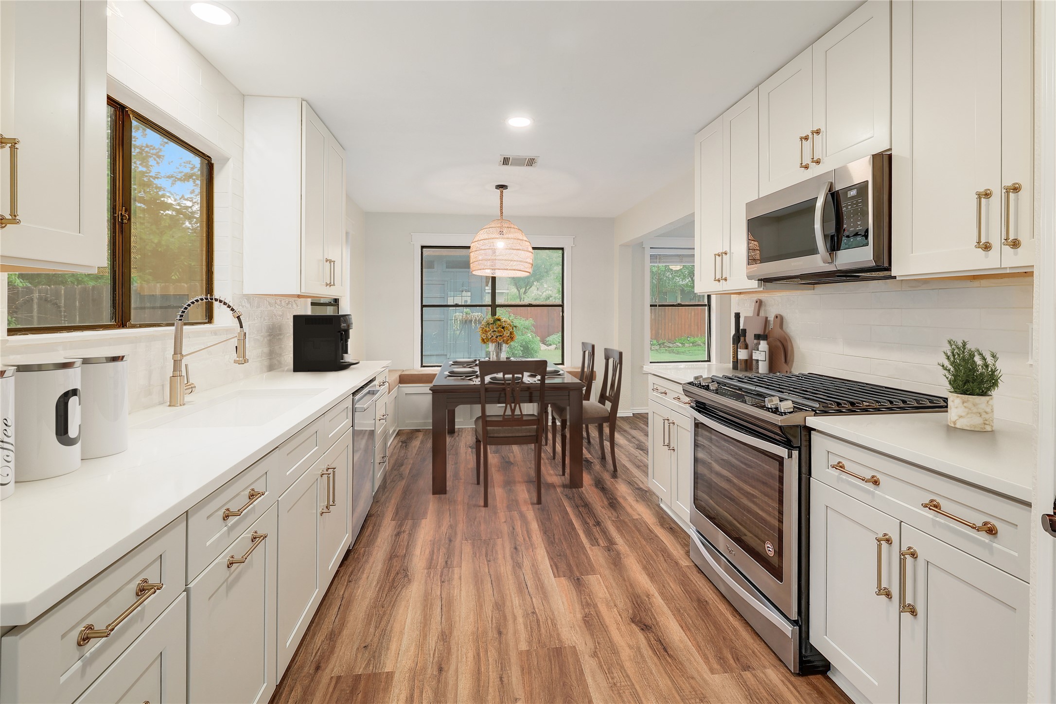 409 Cedar Mound Pass Cedar Park, TX 78613 - Photo 6 of 18 a kitchen with stainless steel appliances a stove sink microwave and cabinets