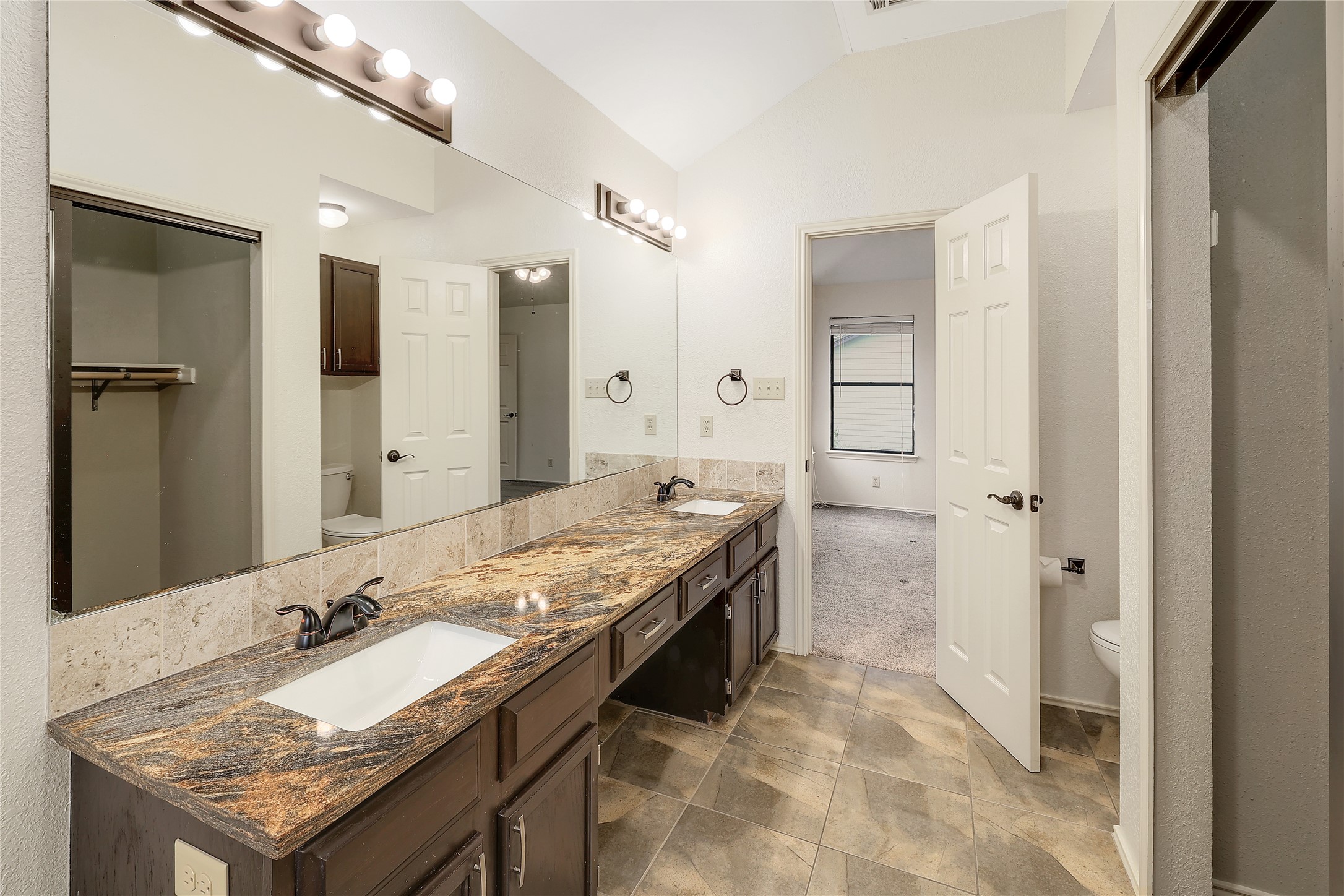 409 Cedar Mound Pass Cedar Park, TX 78613 - Photo 10 of 18 a bathroom with a granite countertop sink a mirror and a shower