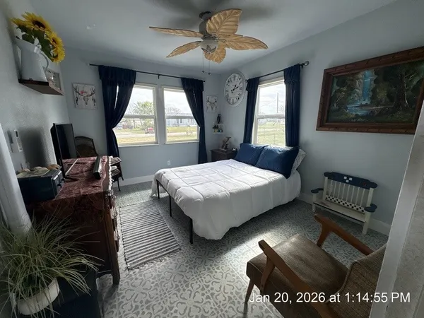 a bedroom with a bed and a chair
