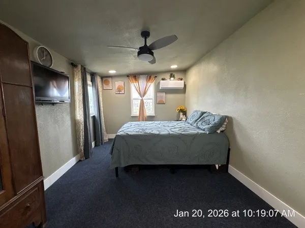 a spacious bedroom with a bed and large windows