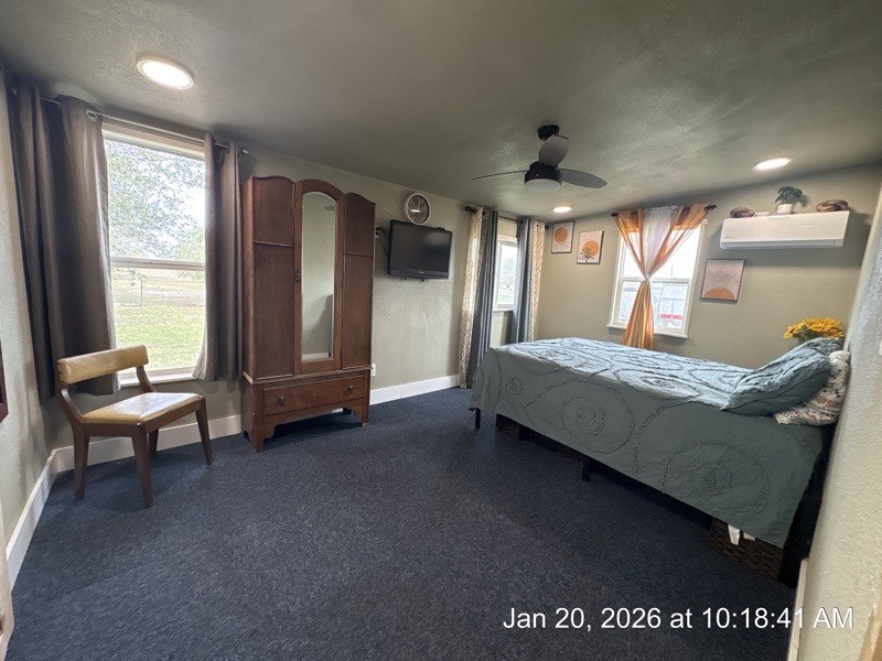 527 2nd Street Bayside, TX 78340 - Photo 21 of 32 a spacious bedroom with a bed and large windows