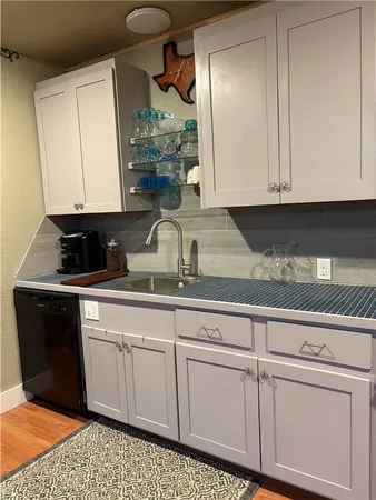a kitchen with stainless steel appliances granite countertop a sink a stove and refrigerator