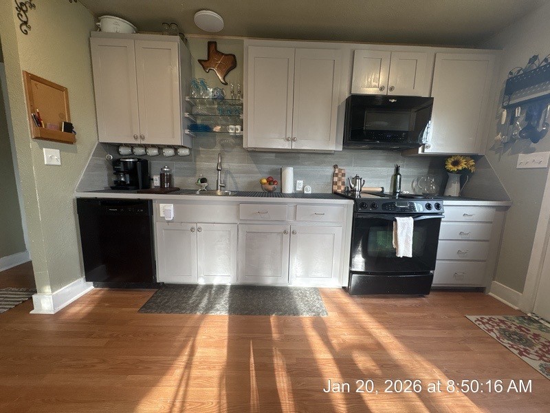 527 2nd Street Bayside, TX 78340 - Photo 8 of 32 a kitchen with stainless steel appliances granite countertop a stove a sink and a microwave