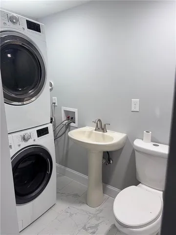 a white toilet sitting next to a bathroom sink