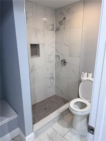 a view of empty room with wooden floor and windows