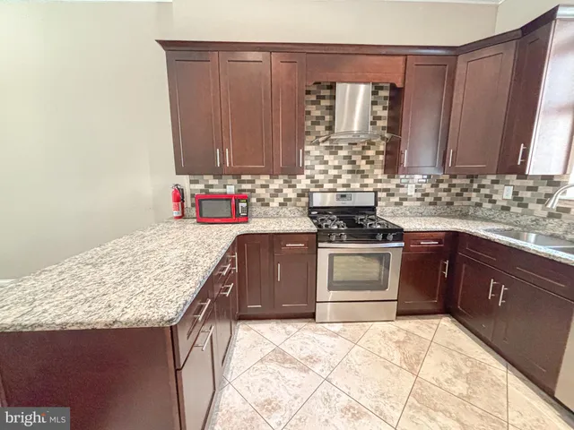 a kitchen with a stove and a sink