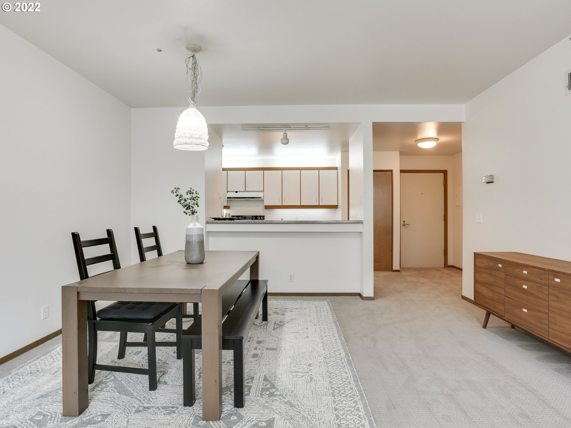 1730 South Harbor Way, Unit 405 Portland, OR 97201 - Photo 13 of 32 a view of a kitchen and a dining room with chandelier