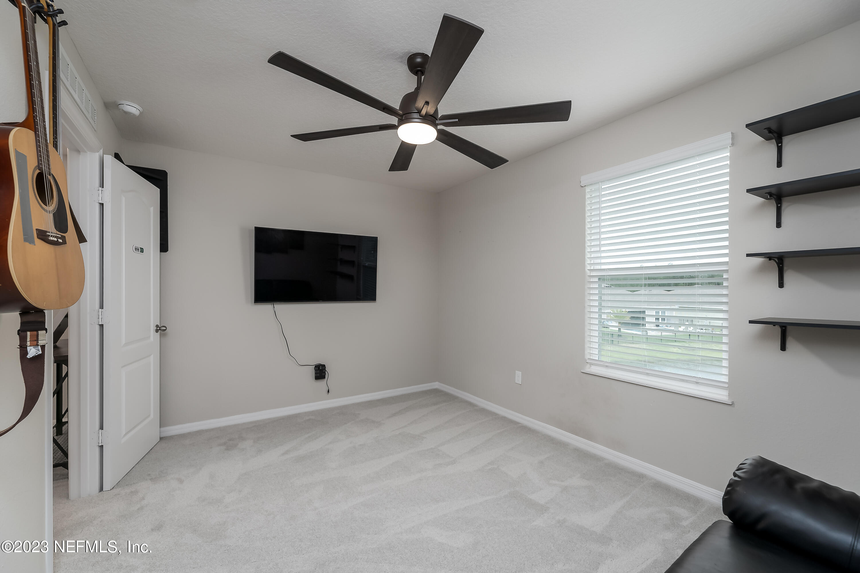 101 Deer Trail St. Augustine, FL 32095 - Photo 13 of 22 a view of an empty room with window and a ceiling fan