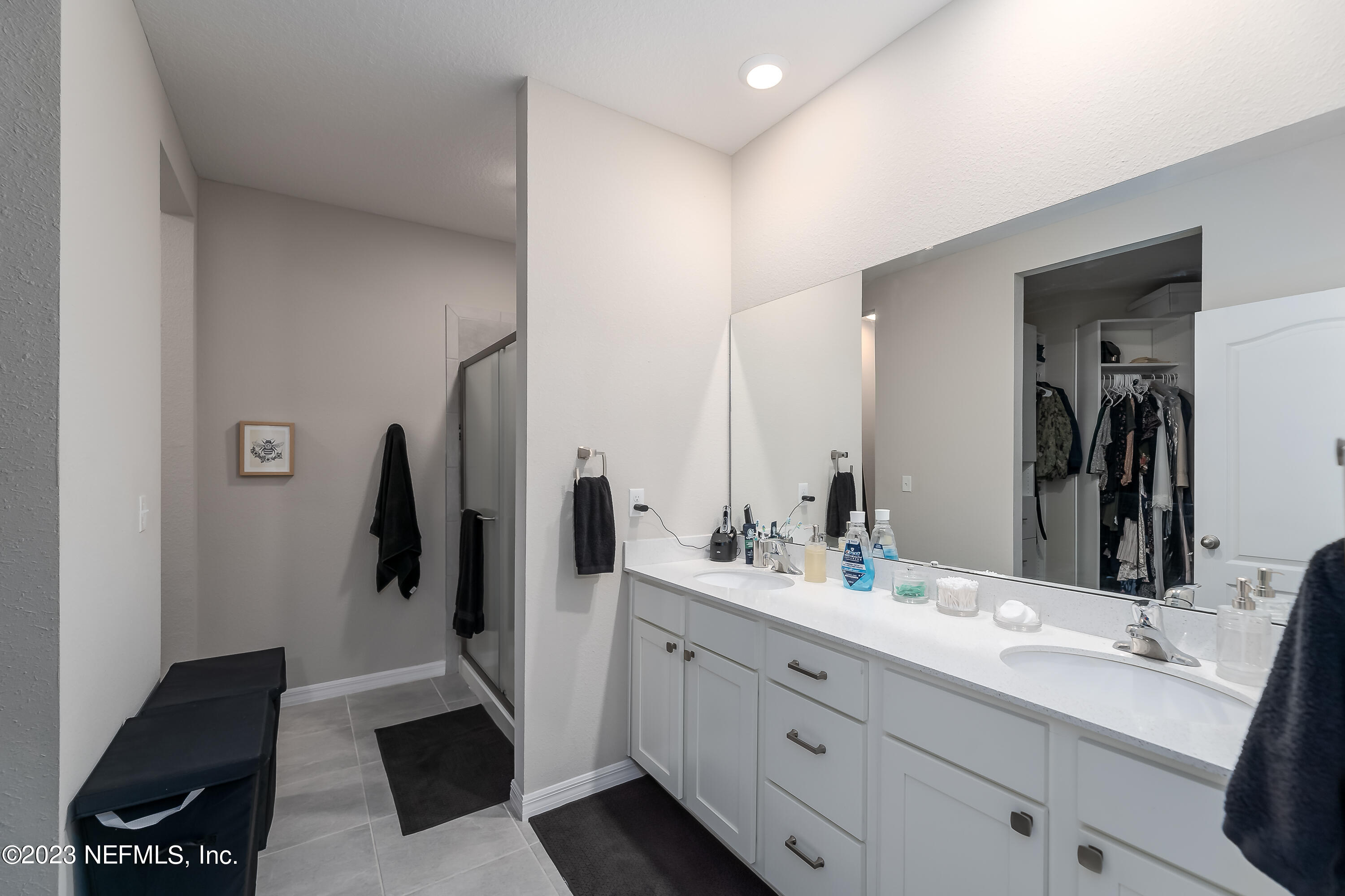 101 Deer Trail St. Augustine, FL 32095 - Photo 8 of 22 a bathroom with a double vanity sink and mirror