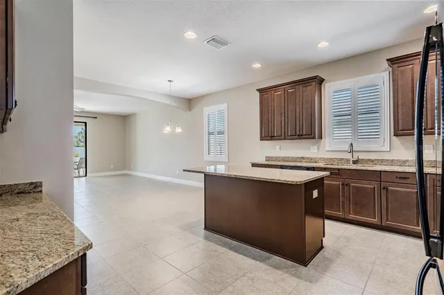 a kitchen with granite countertop a sink and a stove