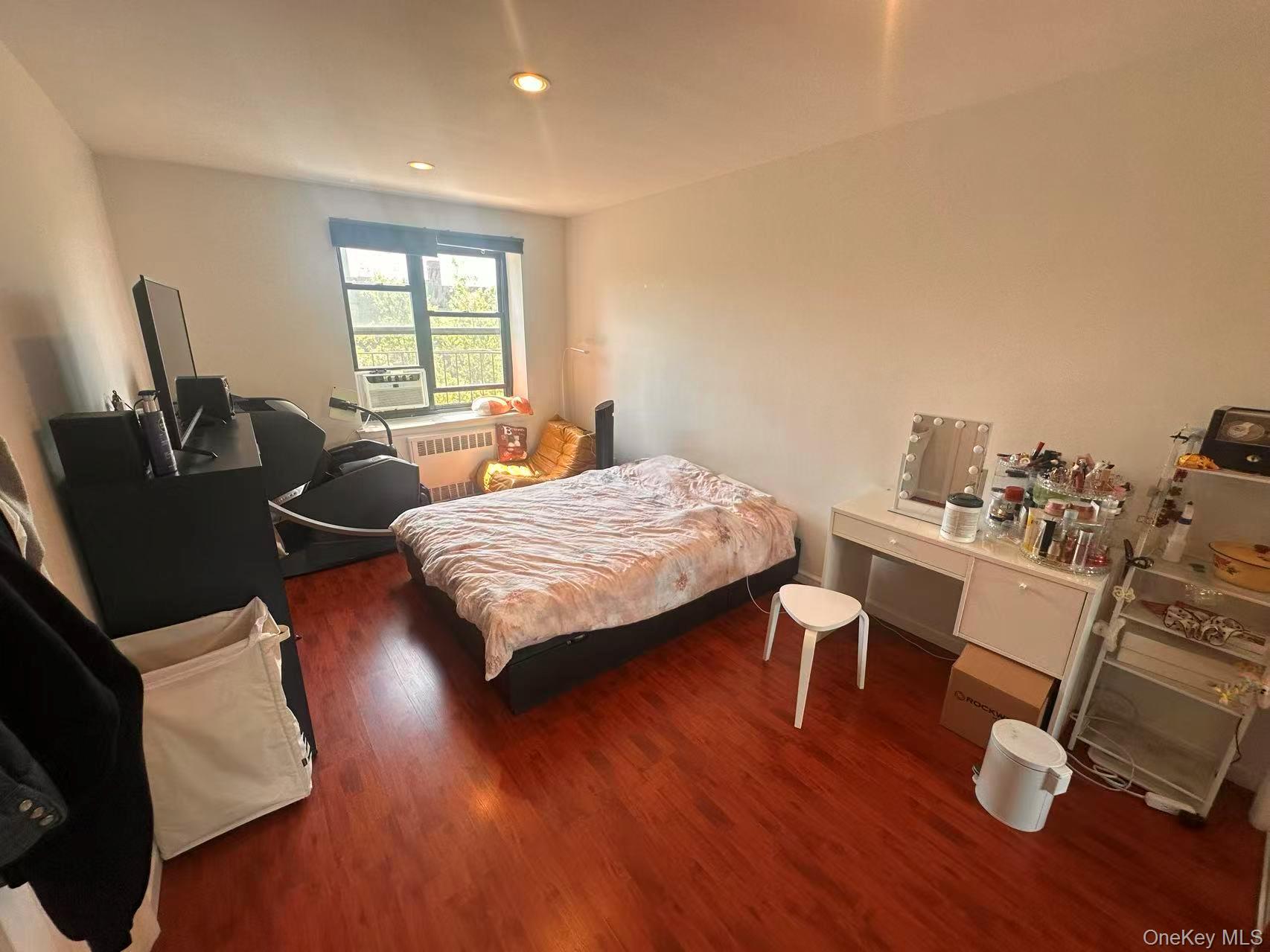 139-15 28th Road, Unit 6G Queens, NY 11354 - Photo 10 of 20 a bedroom with a bed and wooden floor