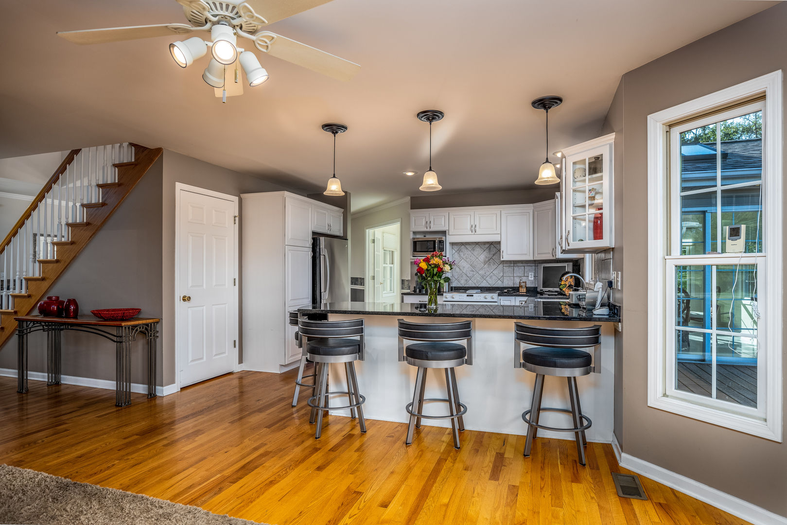 2656 East 1559th Road Ottawa, IL 61350 - Photo 25 of 49 a kitchen with stainless steel appliances granite countertop a stove top oven a refrigerator a dining table and chairs with wooden floor
