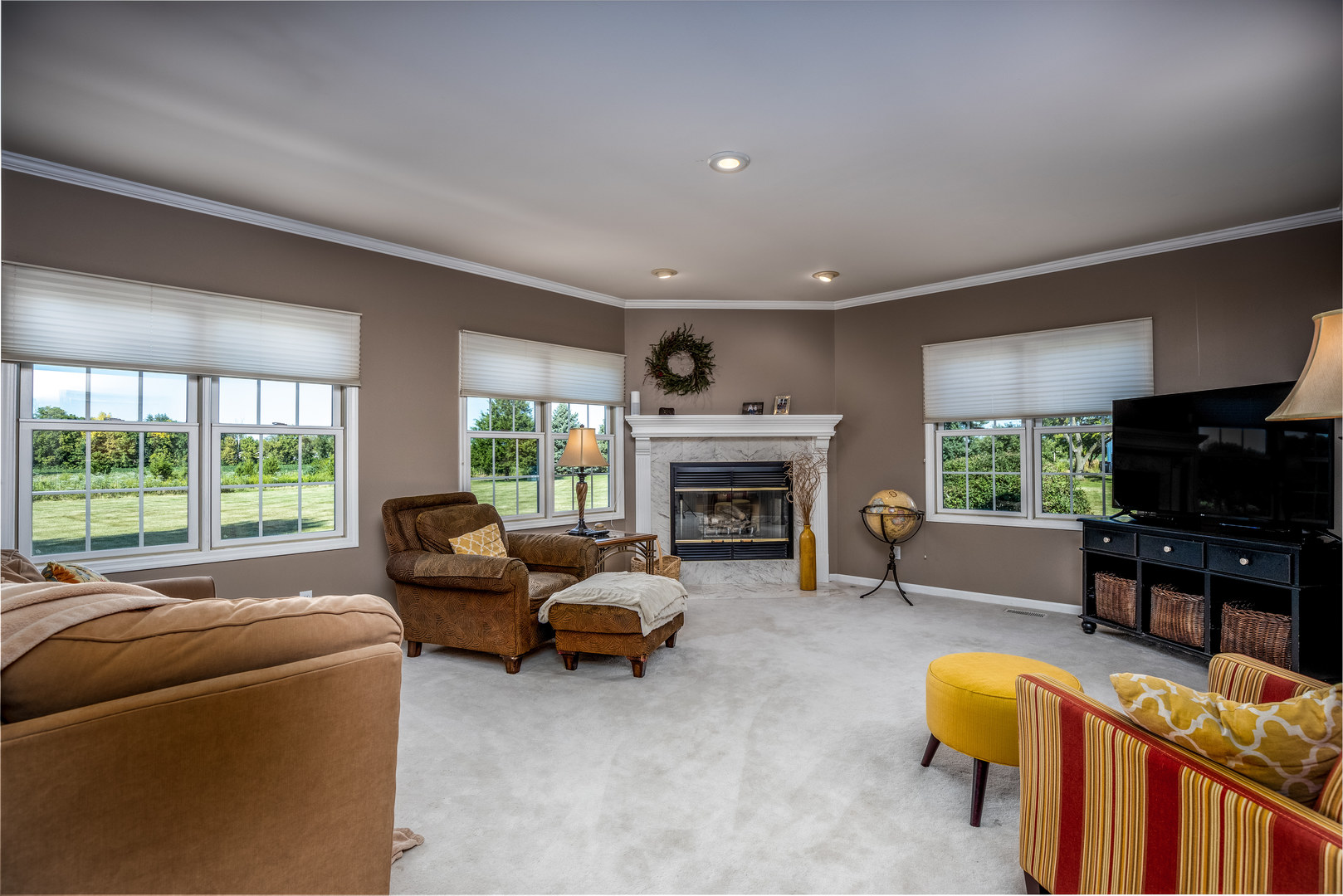 2656 East 1559th Road Ottawa, IL 61350 - Photo 27 of 49 a living room with furniture a fireplace and a flat screen tv