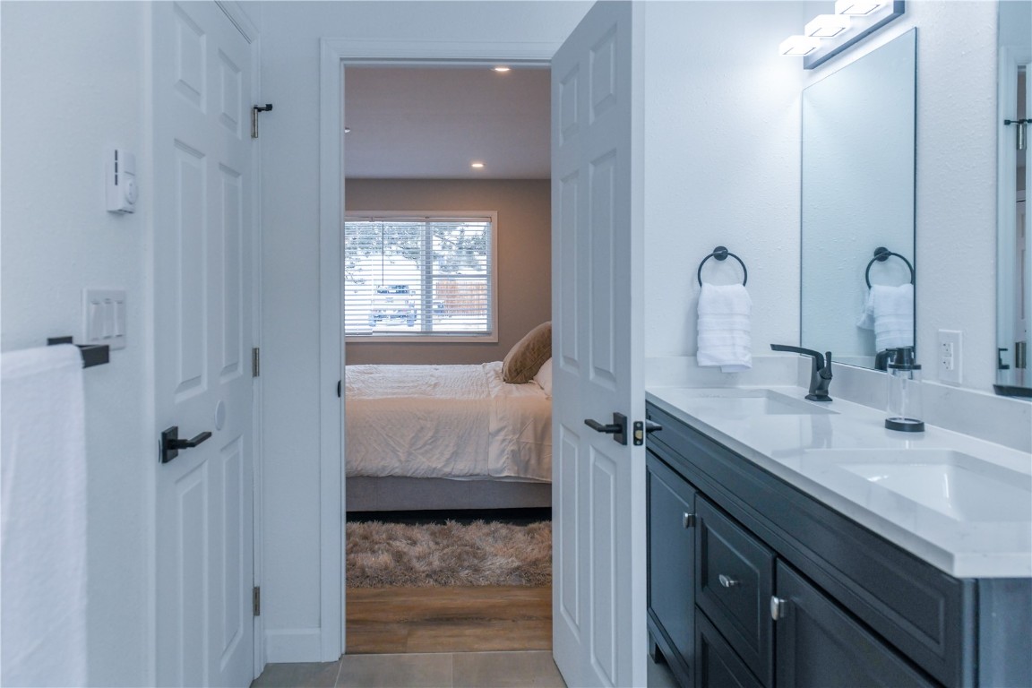 452 Cascade Circle Silverthorne, CO 80498 - Photo 22 of 35 a en suite bathroom with a granite countertop sink and a mirror