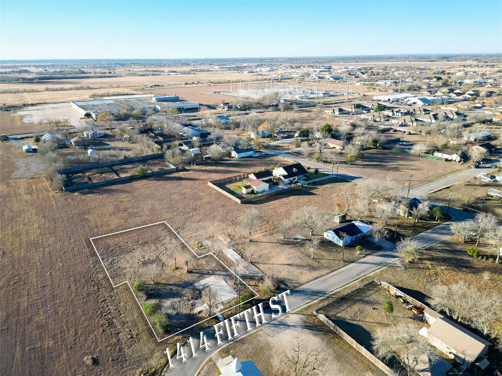 1414 5th Lockhart, TX 78644 - Photo 1 of 8 an aerial view of residential houses with outdoor space