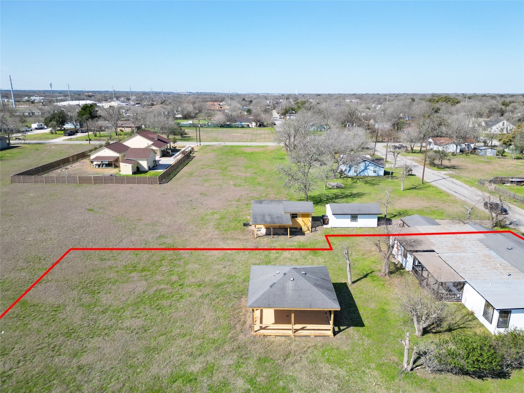 1414 5th Lockhart, TX 78644 - Photo 3 of 9 an aerial view of a house with a swimming pool