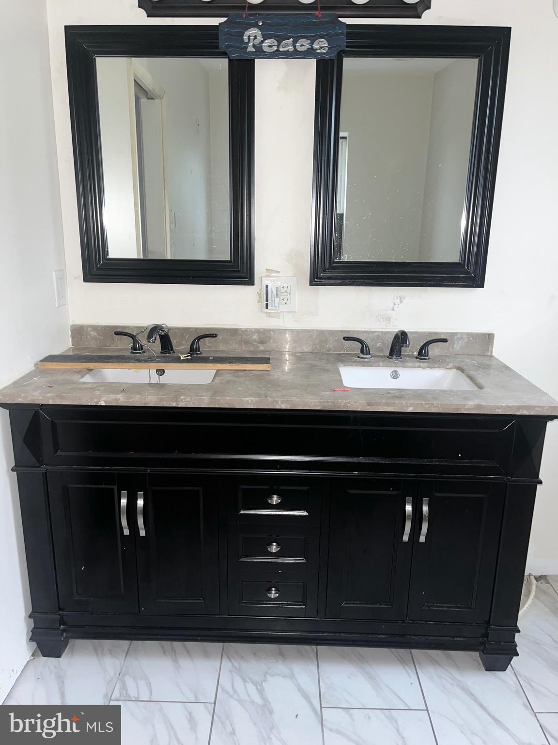 1351 Grove Street Philadelphia, PA 19146 - Photo 4 of 8 a bathroom with a sink vanity and a mirror