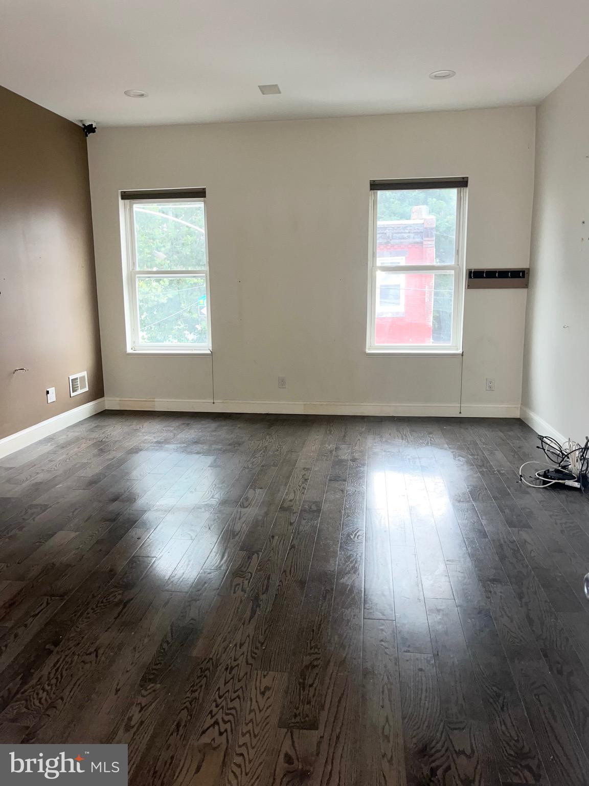 1351 Grove Street Philadelphia, PA 19146 - Photo 6 of 8 an empty room with wooden floor and windows